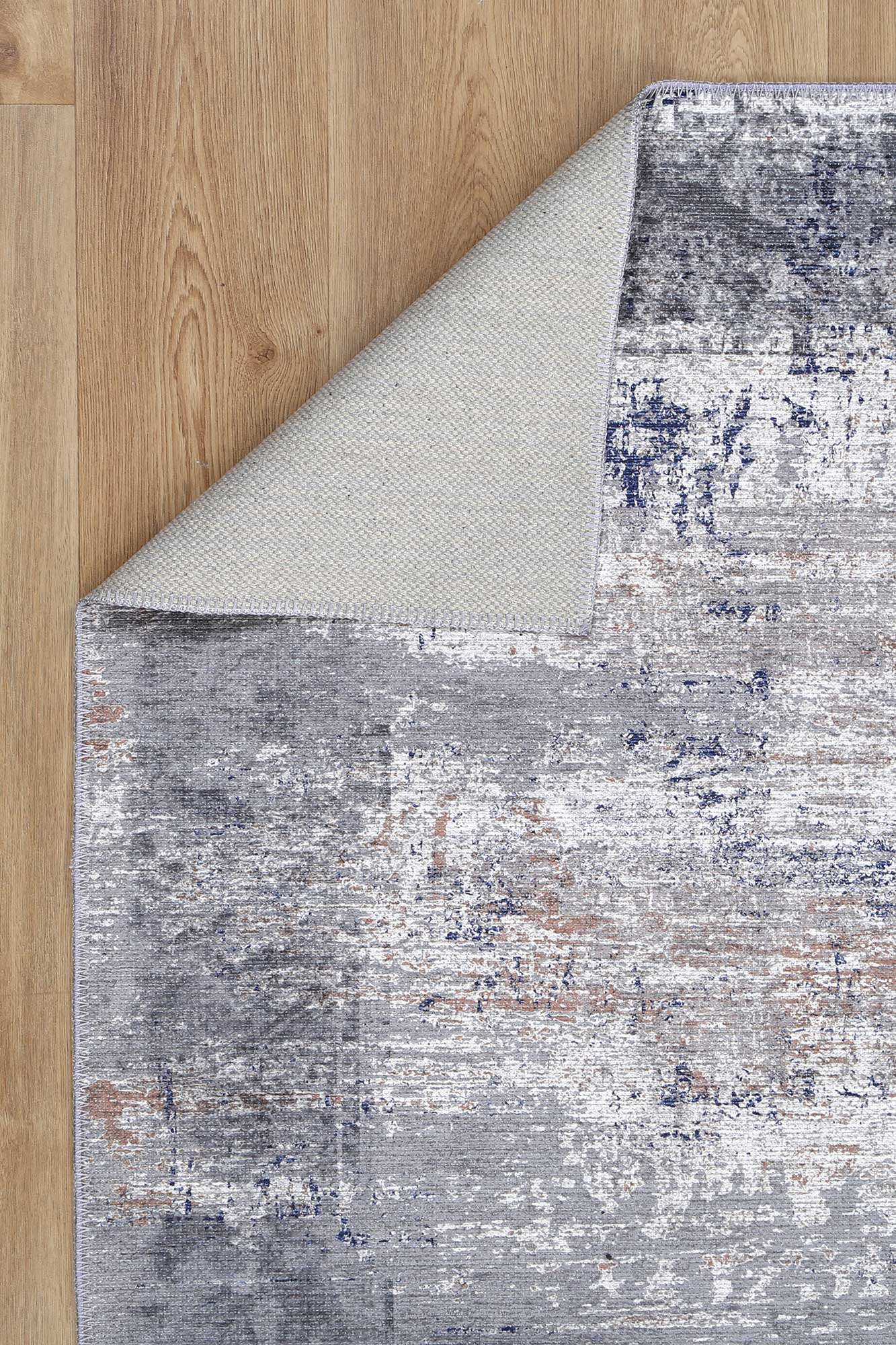 Chic grey rug with an abstract blue and grey design. Stain and water-resistant, anti-allergen, and eco-friendly.