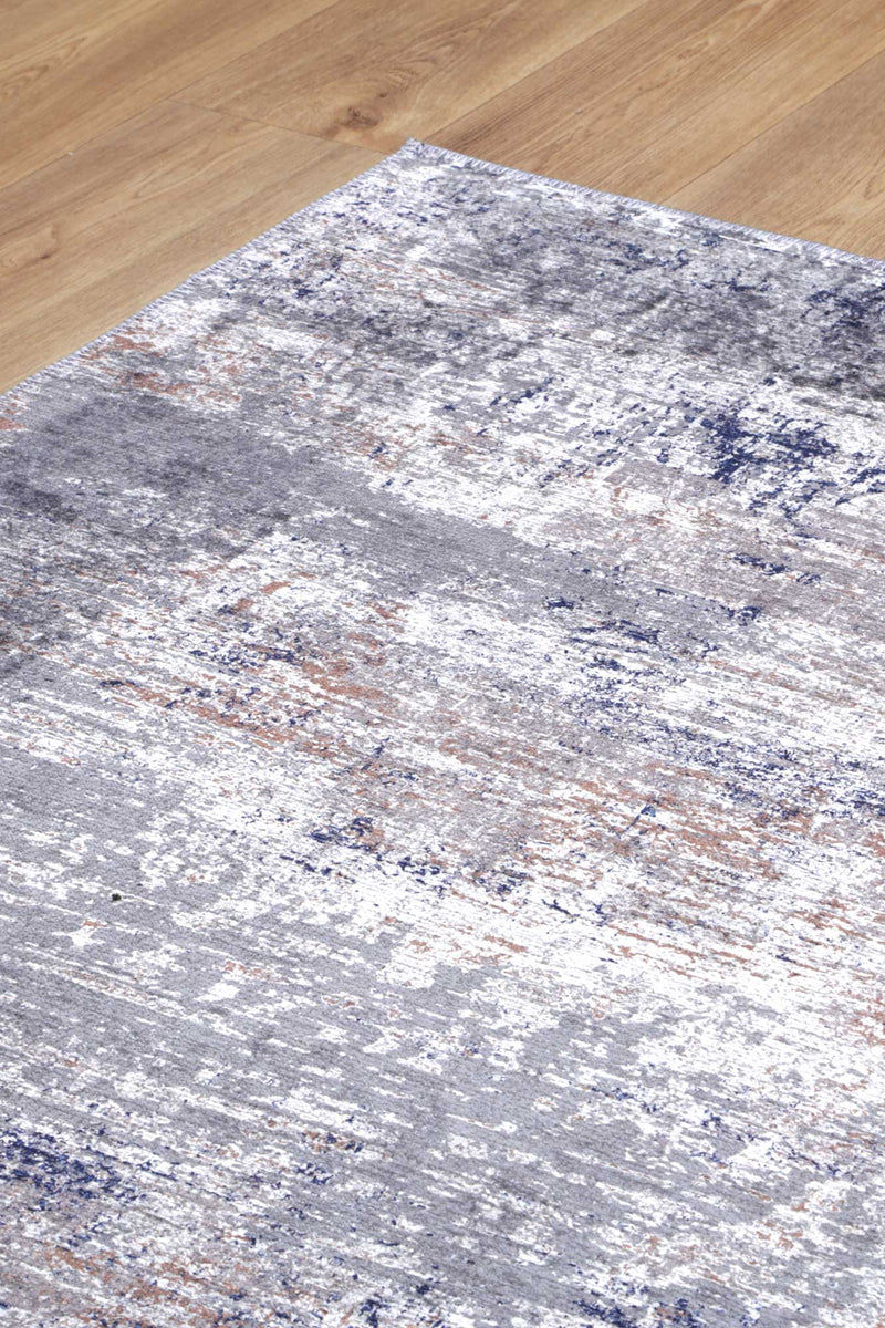 Sophisticated blue and grey abstract rug with a subtle distressed border. Easy to clean and durable.