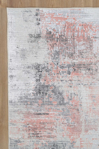 Transform your living space with the Abstract Celine Blush Rug. Soft cotton blend with pink, grey, and cream abstract design. Stain and water-resistant with NanoWipe technology, machine washable, and anti-allergen.
