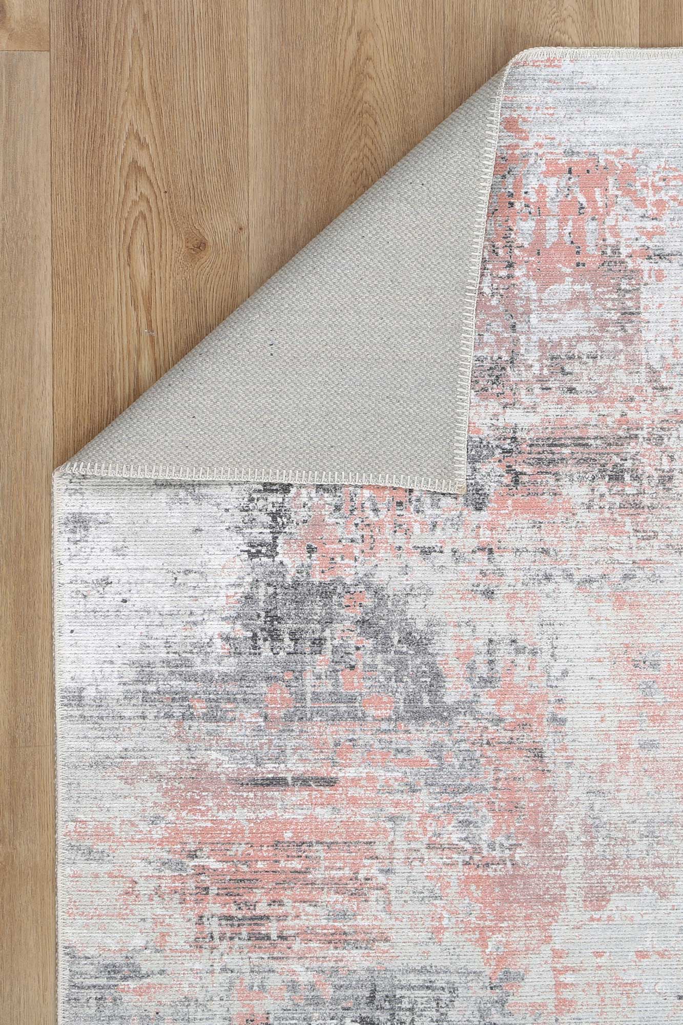 Elevate your home decor with the Abstract Celine Blush Rug. Made from recycled cotton with pink, grey, and cream abstract design. Stain and water-resistant with NanoWipe technology, machine washable, and anti-allergen for easy maintenance.