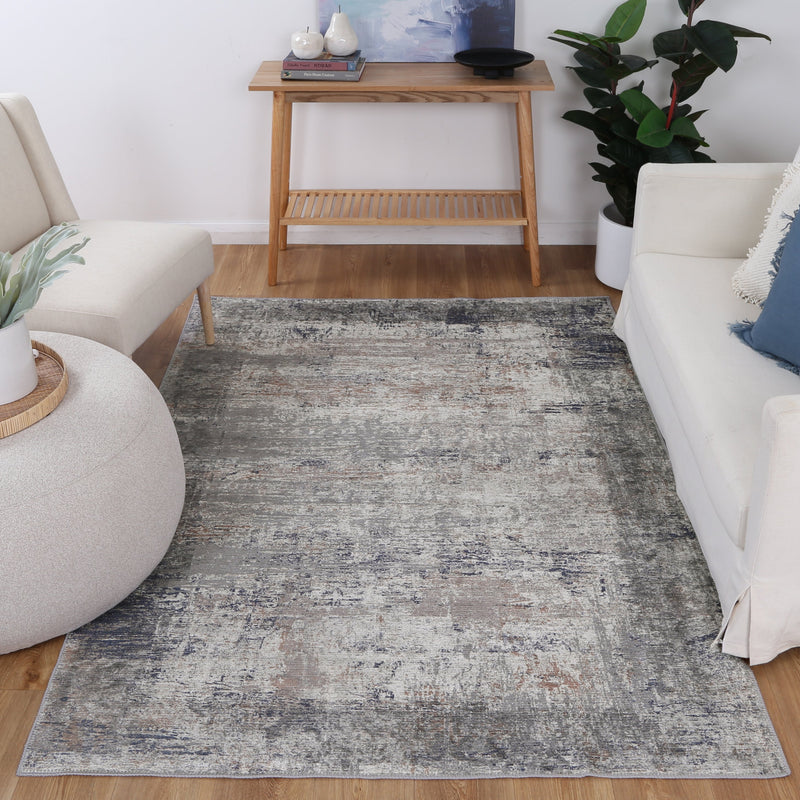 Elegant grey rug with blue and grey abstract design. Stain and water-resistant, anti-allergen, machine washable.