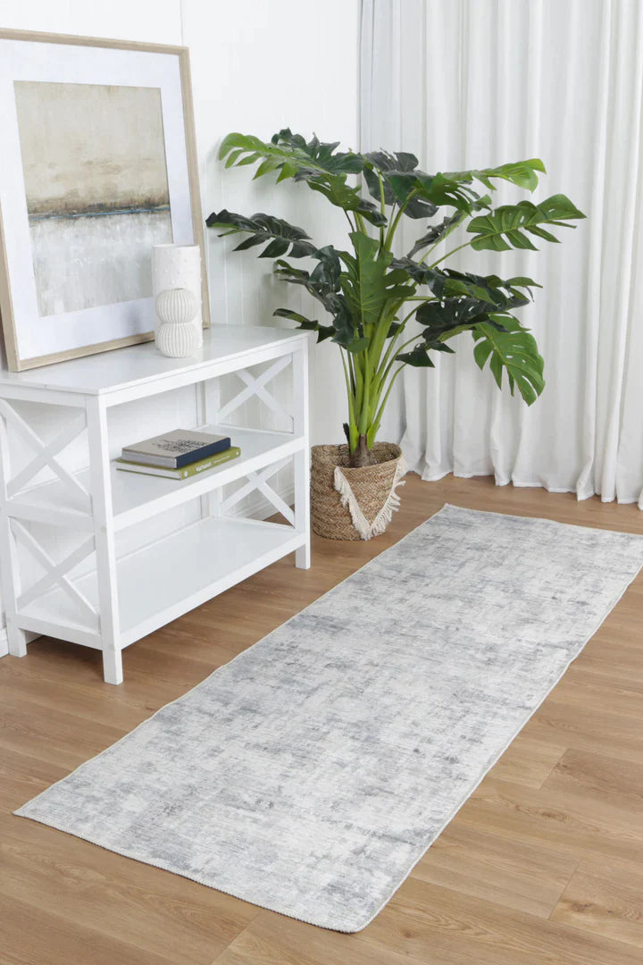 Add sophistication to your living space with the Abstract Evalina Grey Runner. Purposefully distressed design complements any decor. Made from recycled cotton with stain and water-resistant NanoWipe technology. Machine washable and anti-allergen.