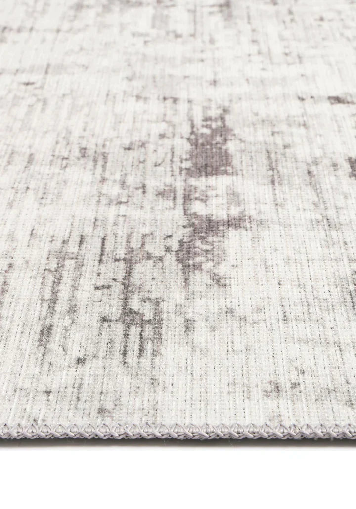Elevate your home decor with the Abstract Evalina Grey Runner. Subtle distressed design in grey, made from recycled cotton. Stain and water-resistant with NanoWipe technology, machine washable, and anti-allergen for easy cleaning and care.